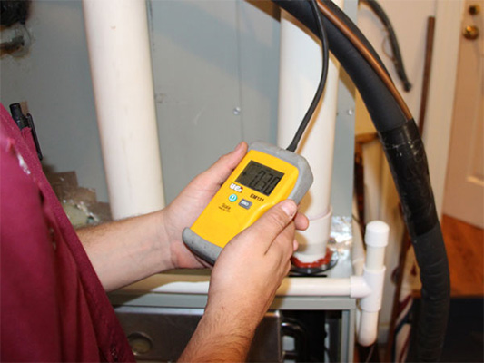 Technician providing air conditioner maintenance