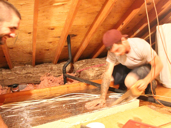 Male technician sealing a homeowners attic door