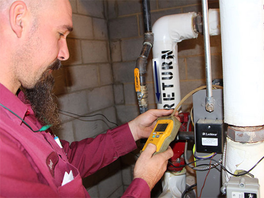 Technician providing boiler maintenance