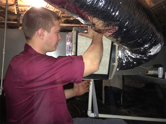 Male technician performing a test for duct performance