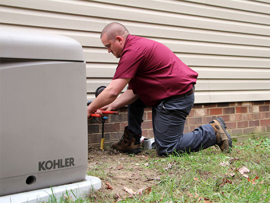 Technician installing a generator