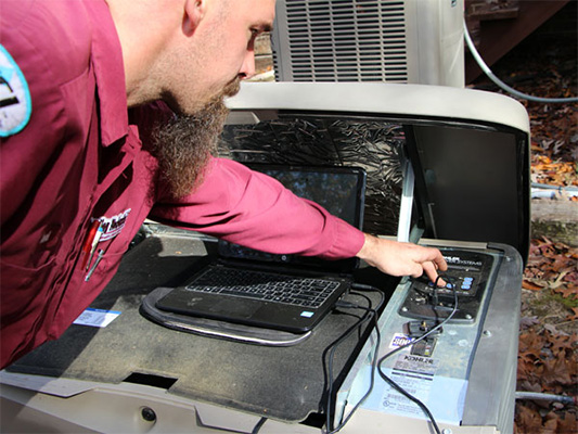 Technician repairing a generator
