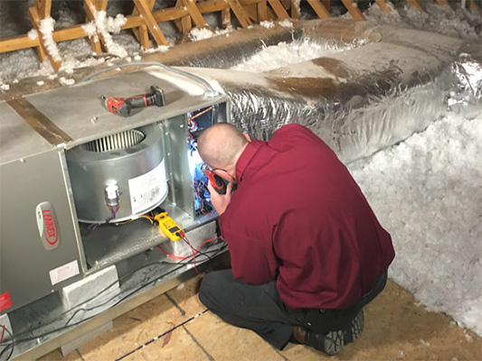 Technician providing heat pump maintenance