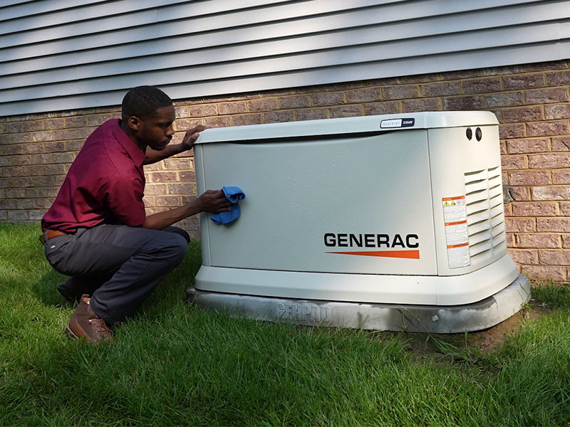 Bradley Mechanical technician cleaning a newly installed Generac generator