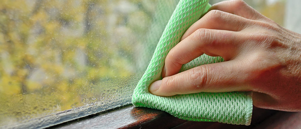 Person wiping window with a cloth because of low humidity
