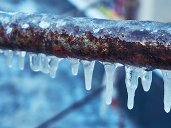 plumbing problem frozen pipes with icicles on them
