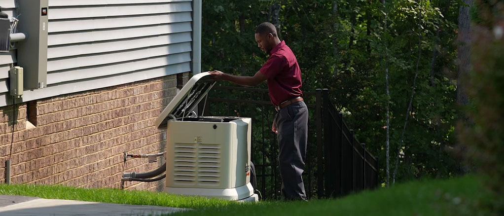 Bradley Mechanical technician looking at a Generac generator on the side of a house